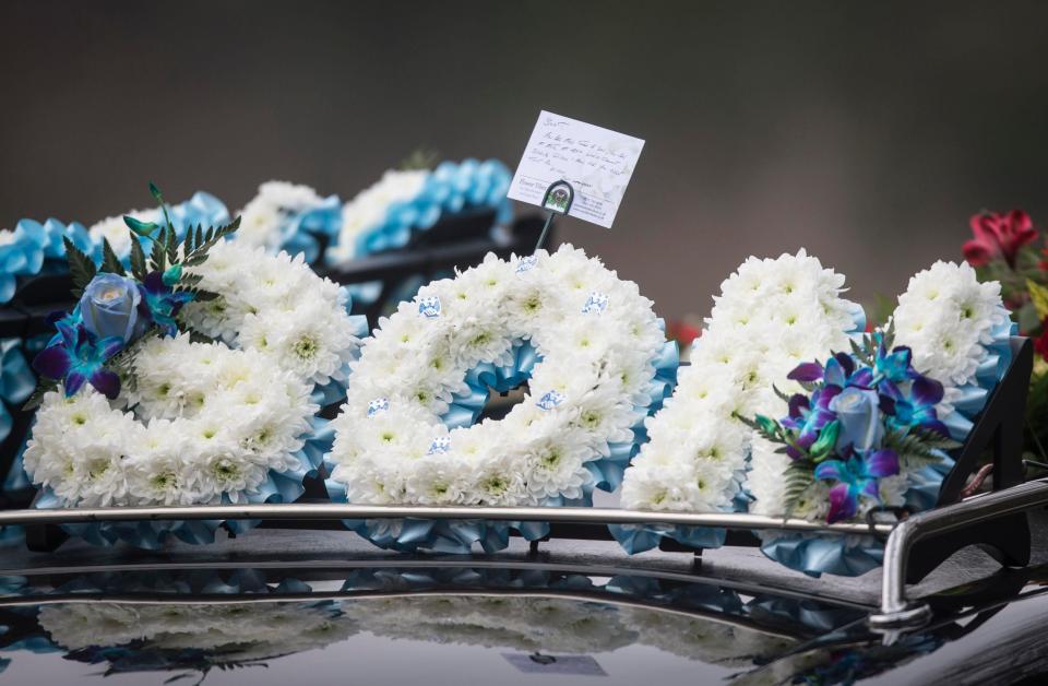 Floral tributes to Son and Daddy were laid on the hearse as it pulled up to the church