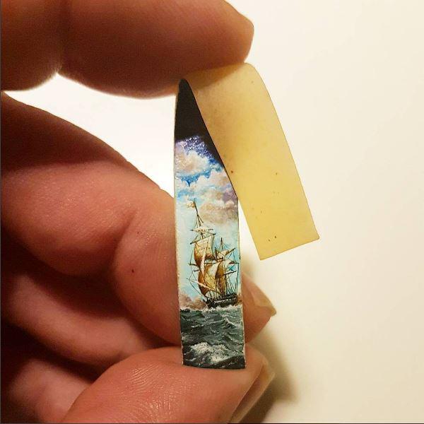 The tiny art is also painted on a strip of pasta 