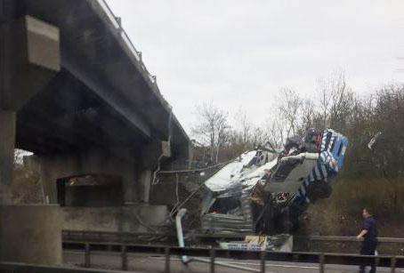 The crumpled lorry could be seen lying on the road after it is thought to have tumbled from the bridge above