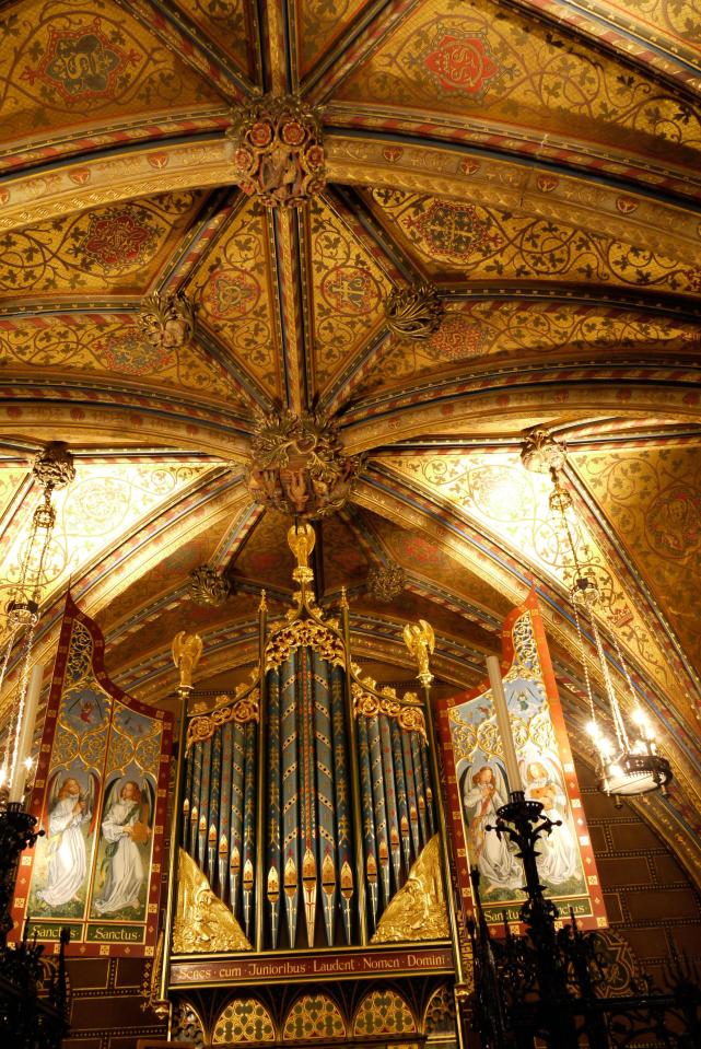  Highly decorated vault ceiling features a prominent organ