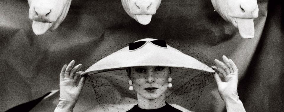  A glamorous image by Guy Bourdin for French Vogue in 1955 sees a model pose in an almost saucer-like hat as a black veil hangs in front of her face (Guy Bourdin, French Vogue, February 1955 © Estate of Guy Bourdin. Reproduced by permission of Art + Commerce)