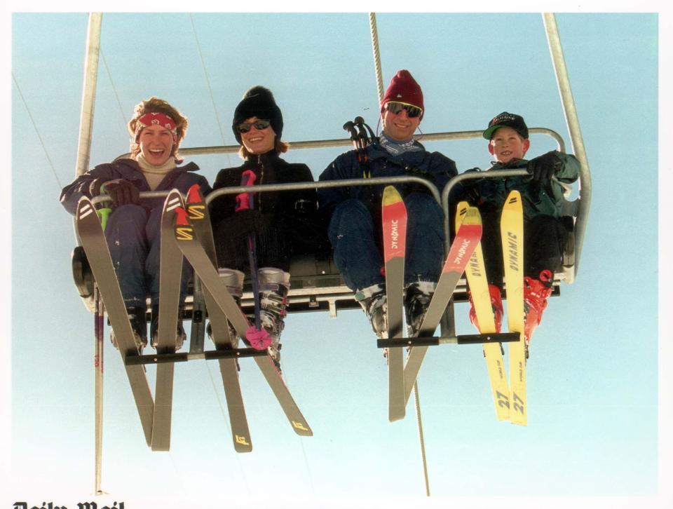 Smiling on a ski-lift with Prince Charlies and Prince Harry at Klosters in 1997