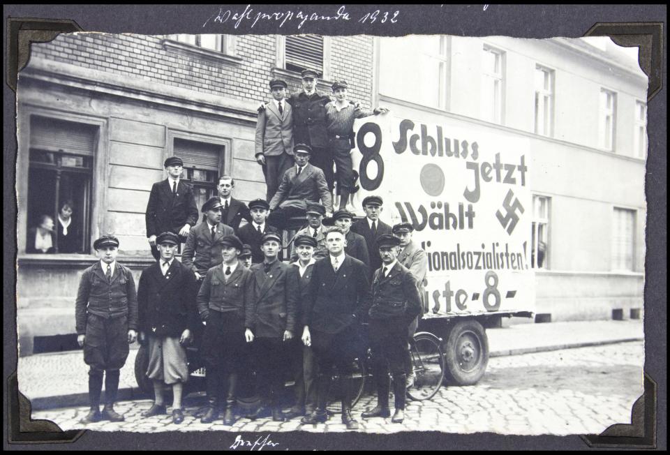 An early meeting of SS members beside a propaganda truck