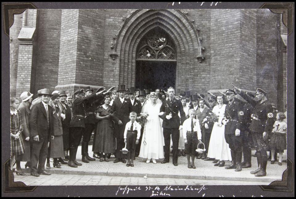 An SS officer receives the Nazi salute from other members on his wedding day