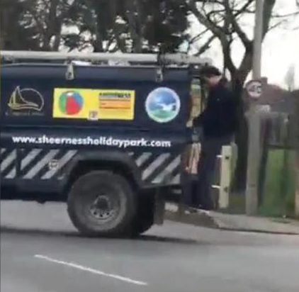  The man clambered on to the back of the Land Rover
