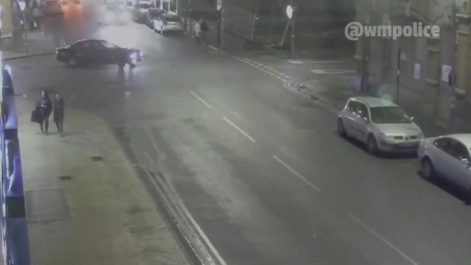 The BMW 5 Series can be seen turning into the road while the two women walk along the pavement