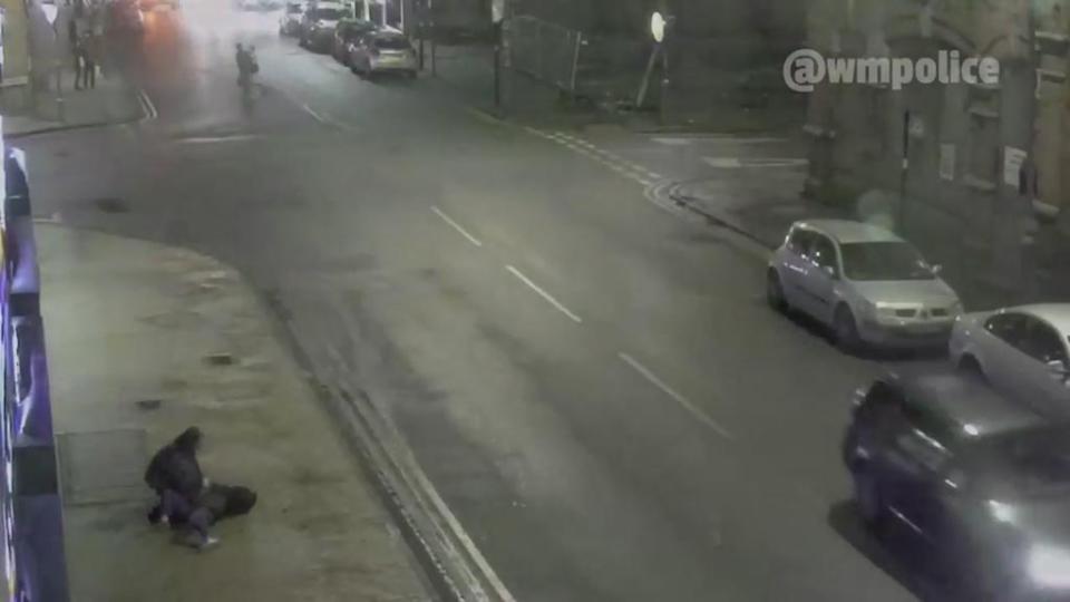 The woman cradles her daughter who is left in a serious condition on the cold pavement 