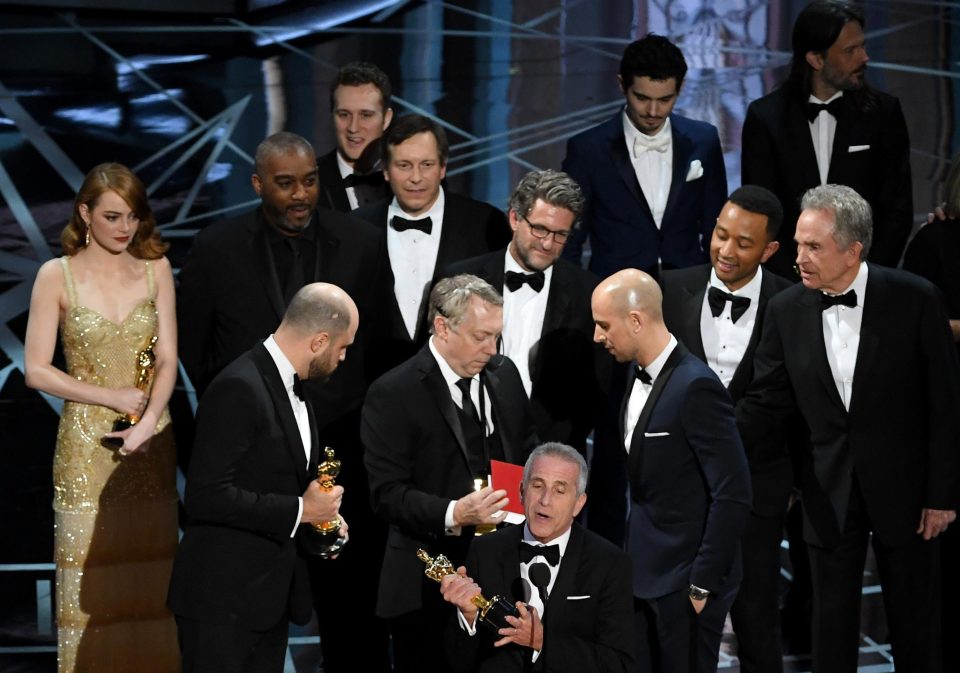 La La Land producer Marc Platt speaks with producers Jordan Horowitz and Fred Berger as production staff consult behind them regarding a presentation error of the best picture award - later awarded to Moonlight
