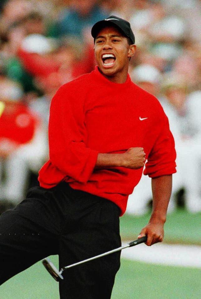  Tiger Woods punches the air in triumph at winning the 1997 Masters