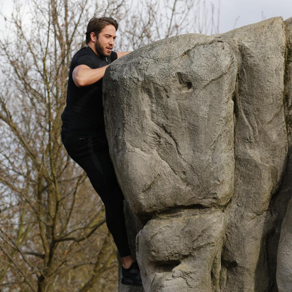  The lads clambered to conquer a large rock