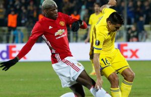 Paul Pogba battles his way through the first leg