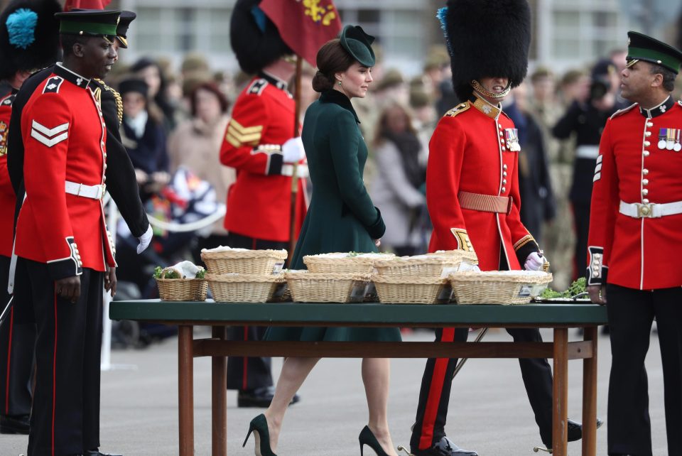  Kate walks by a table with baskets filled with shamrocks with some of the officers after arriving at the parade