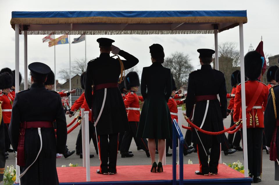  The Duke salutes the officers and guardsmen as they parade by the Royal couple