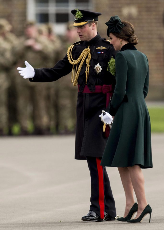  Prince William walks with his wife after she presented officers and guardsmen with sprigs of shamrock