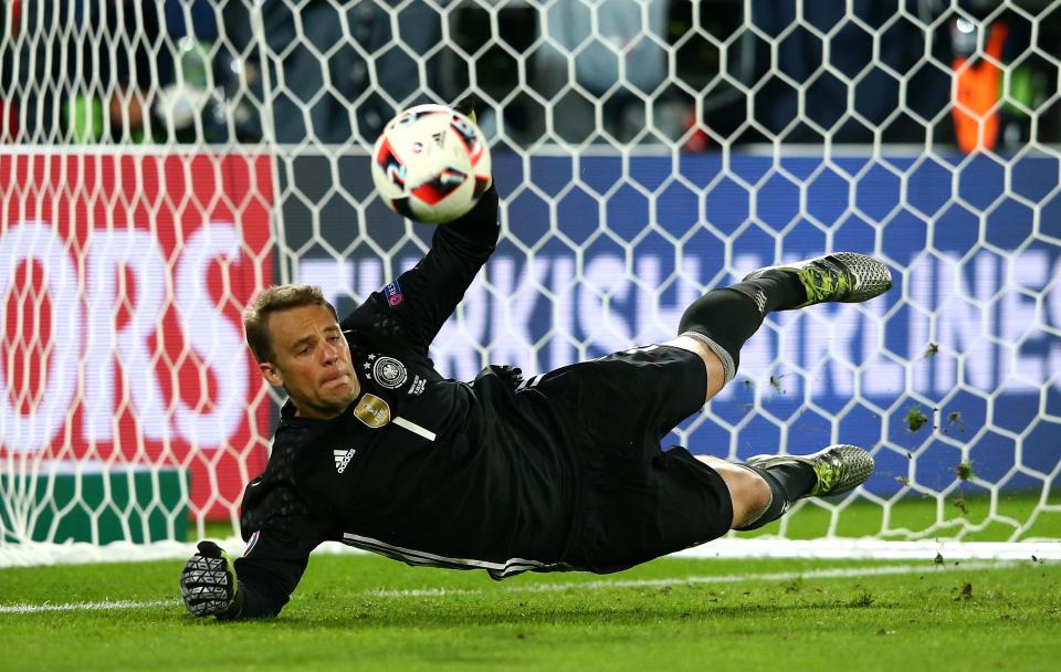 Bayern and Germany keeper Manuel Neuer seen in more typical action - saving a penalty
