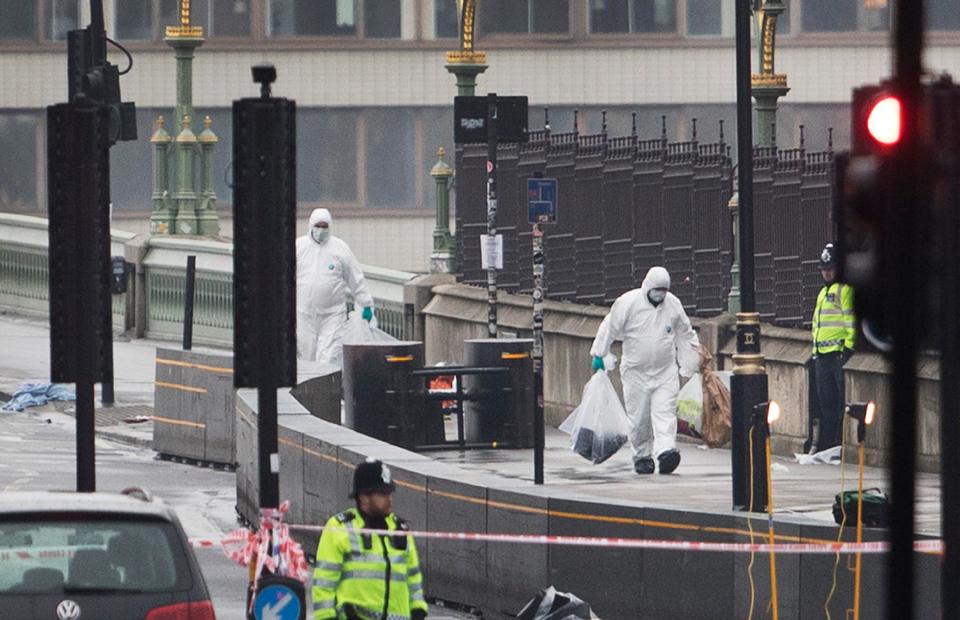 Forensic teams work on Westminster Bridge where a terrorist mowed down crowds yesterday afternoon