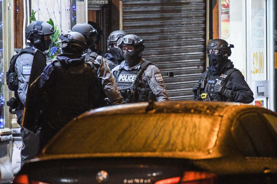 Armed police outside a flat in Birmingham raided by cops late last night as eight were arrested across the UK