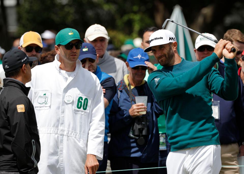 Dustin Johnson grimaces while trying to swing a club