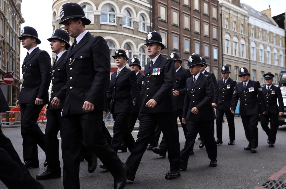  Police officers pictured walking towards Southwark Cathedral as they prepared for PC Palmer's funeral this morning