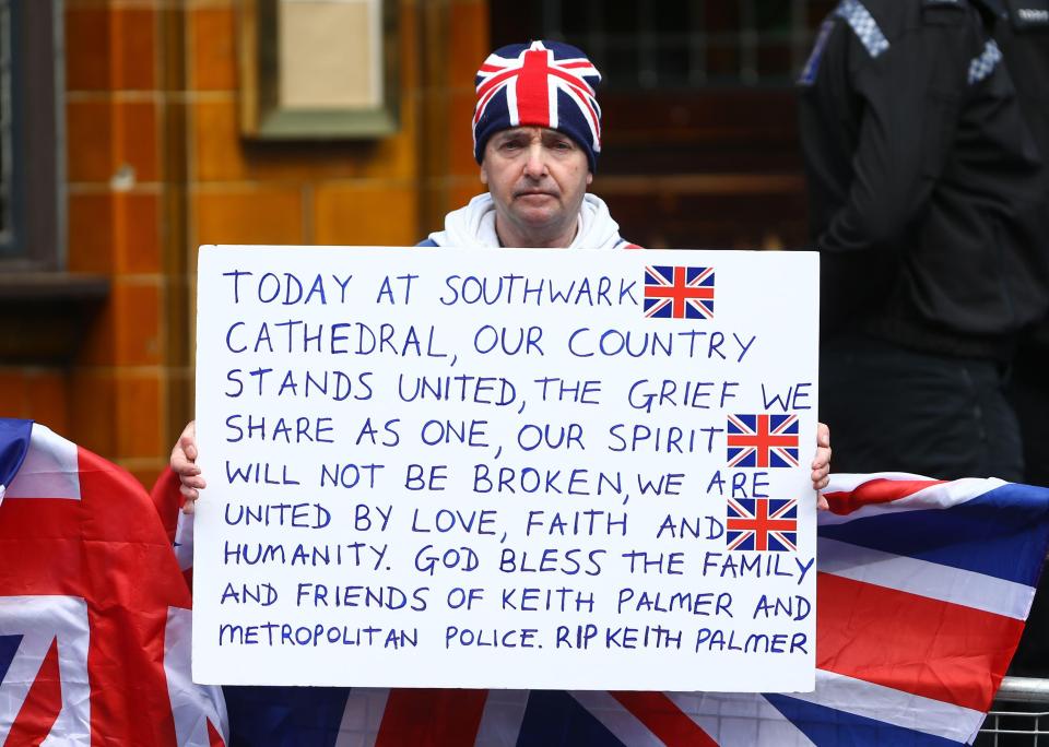  John Loughrey holds a sign outside Southwark Cathedral ahead of PC Palmer's funeral expressing a united front and sympathy for PC Palmer's friends and family