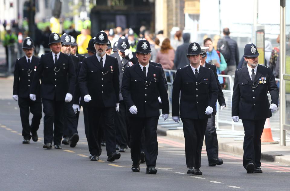  Police officers have marched up to the area where the funeral will be held to line the streets
