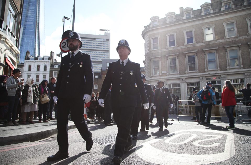  Dozens of cops solemnly walk up through the route where PC Palmer's coffin will be escorted