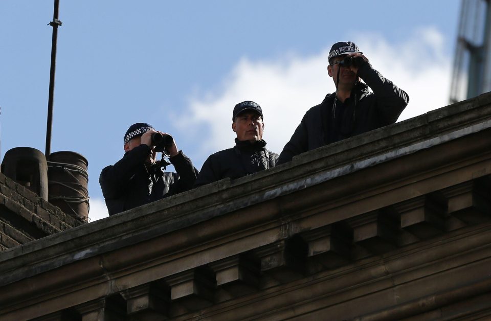  Officers not on the ground as part of the funeral procession are lining the rooftops of the route