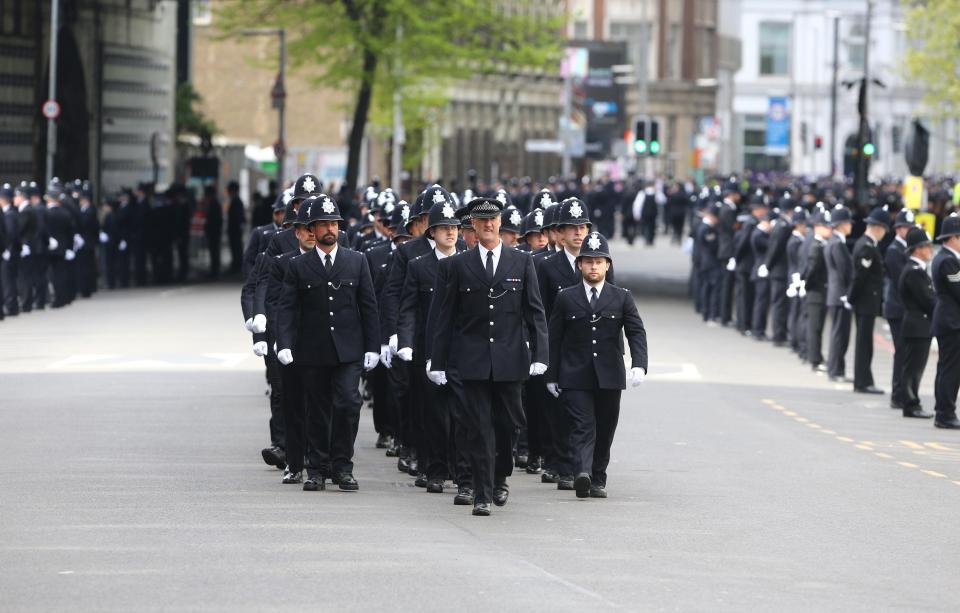  Regimented lines of mourning police officers marched to flank the streets of London as PC Palmer's coffin is brought to Southwark