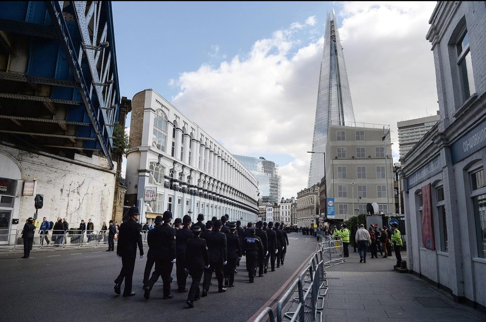  Officers from around the country march towards the iconic Shard as they head towards Southwark Cathedral ahead of PC Palmer's funeral