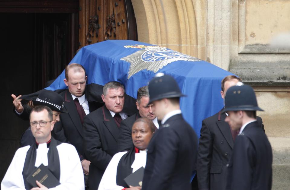  PC Palmer's coffin is carried out from the Palace of Westminster before being placed in the car which will carry it to Southwark