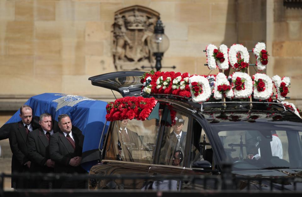  PC Palmer's coffin is placed in the hearse after leaving Westminster before it is taken to Southwark Cathedral