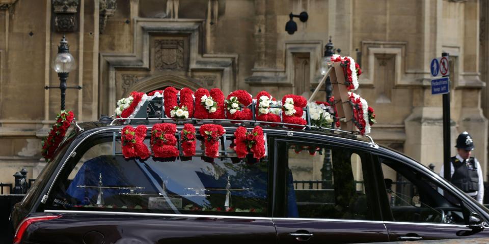  Another floral tribute on the hearse carrying the officer reads "Uncle Keith"