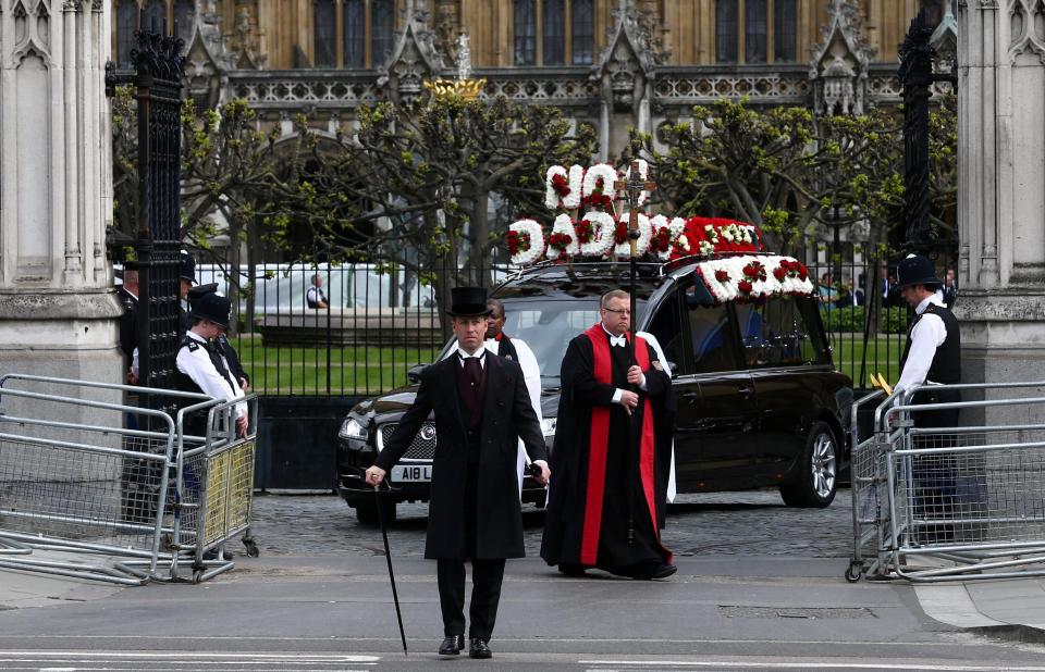  In a hearse with "No1 Daddy" written in flowers, PC Palmer is carried to Southwark