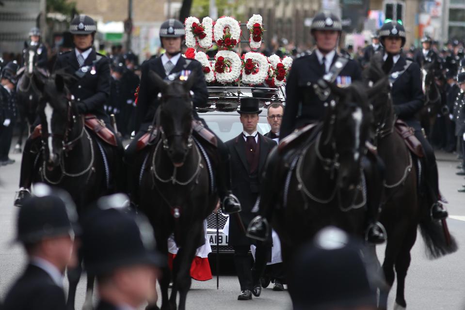  Mounted police officers walk ahead of the hearse carrying the coffin of PC Keith Palmer
