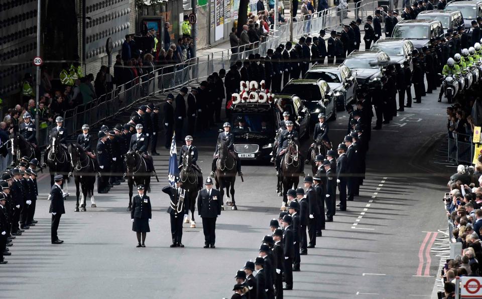  PC Palmer's body is carried in a hearse flanked by officers on foot and horseback as they pay tribute to the heroic cop