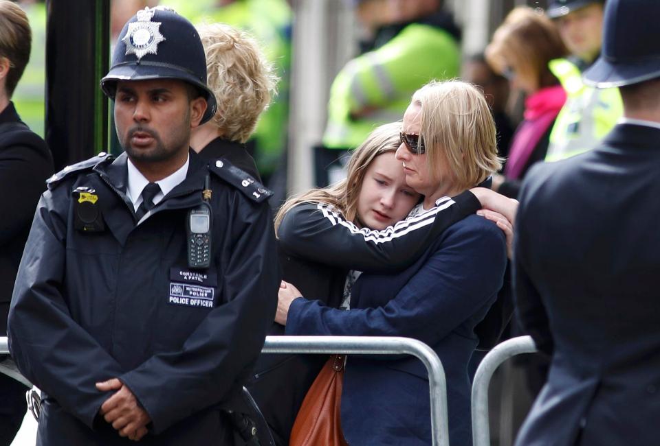  Well-wishers held each other as they listened to the emotional funeral service for PC Palmer