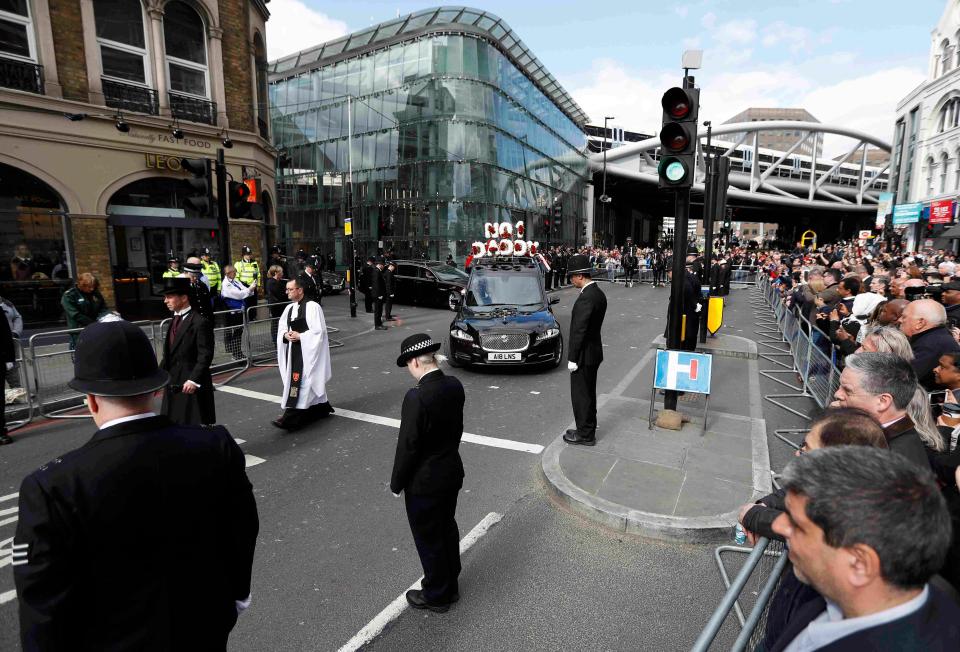  Officers bow their heads as the funeral cortege leaves Southwark following the funeral as PC Palmer is taken to a private cremation
