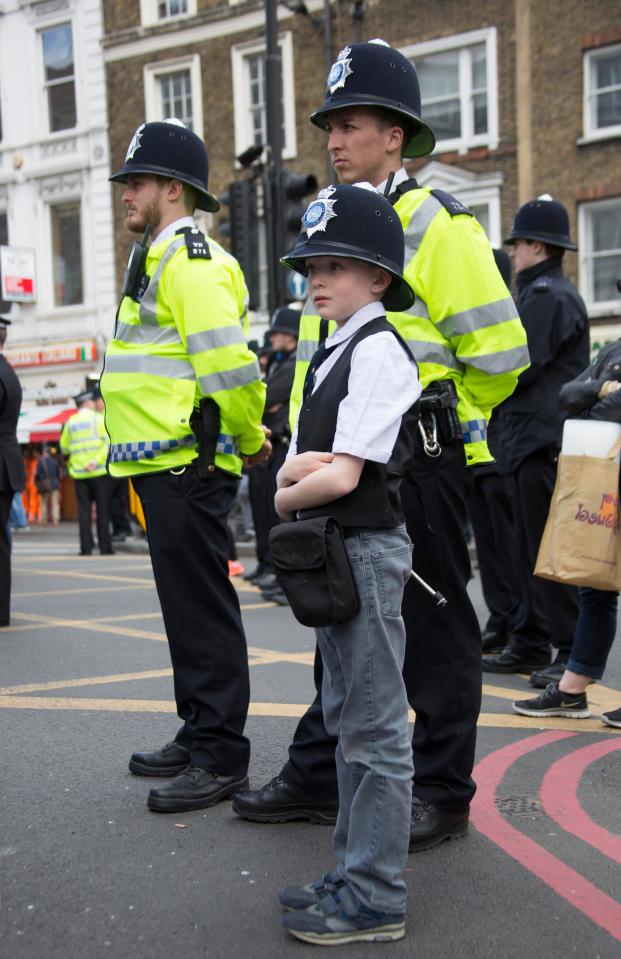 The youngster impressed officers as he stood side by side with uniformed police as they held a minute's silence for their fallen colleague