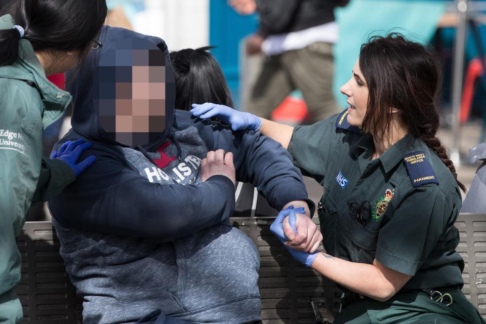 A paramedic can be seen trying to treat the man after it's believed he took Spice