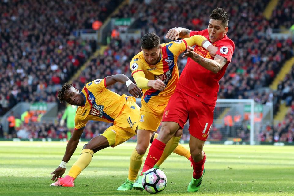 Wilfried Zaha tangles with Roberto Firmino as Crystal Palace stun Liverpool with a 2-1 win at Anfield