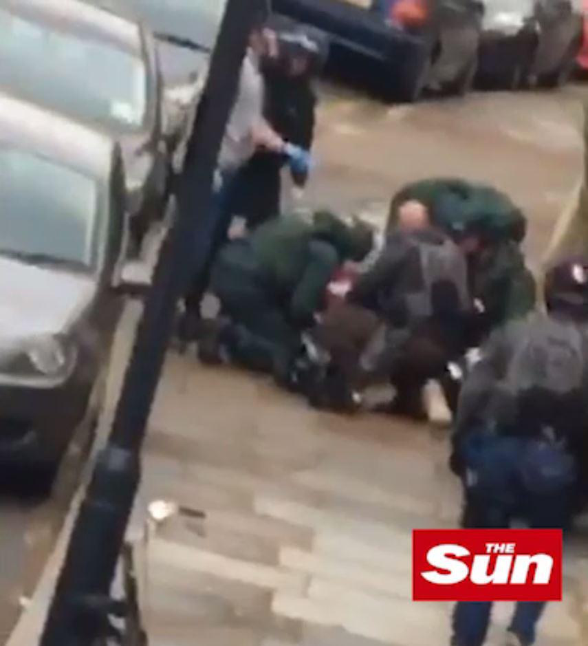 Paramedics could be seen tending to the woman on the pavement outside the house in Willesden, North West London