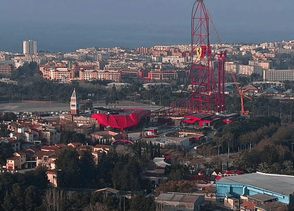 The massive ride dominates the skyline with the iconic Ferrari logo blazoned on its red frame