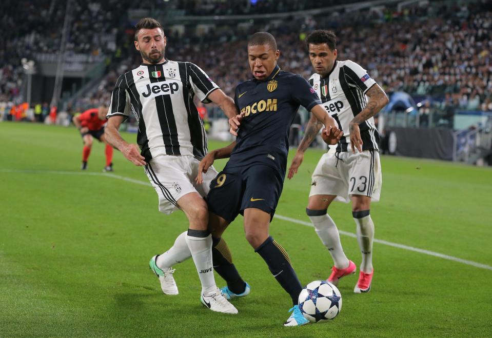 Kylian Mbappe is crowded out by Andrea Barzagli as he comes forward for Monaco
