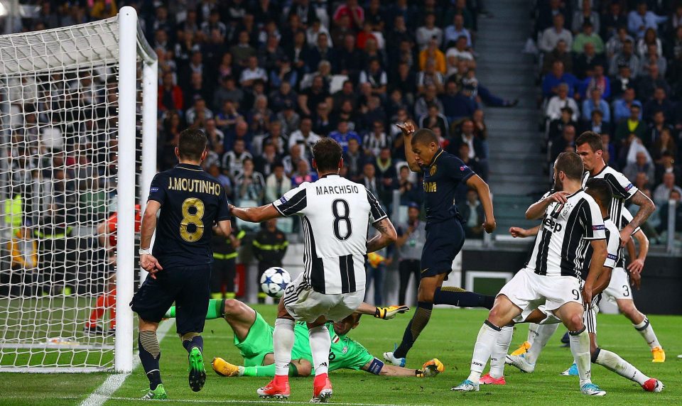 Kylian Mbappe finds a way past the Juventus defence to net Monaco's consolation