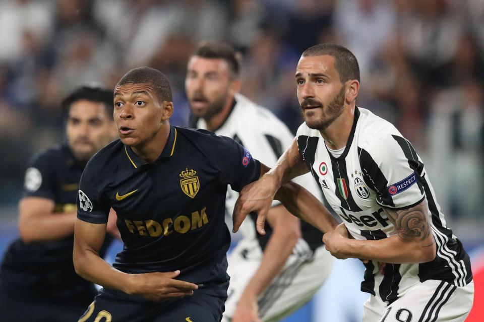 Kylian Mbappe is closely watched by Leonardo Bonucci during attack