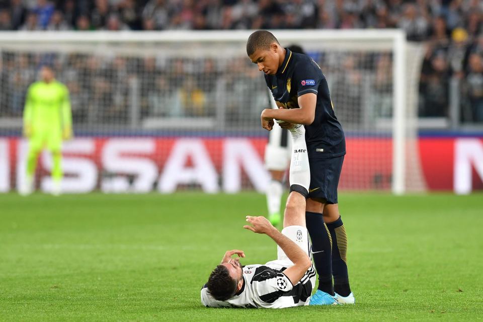 Kylian Mbappe finds the time to help rival, Andrea Barzagli, recover