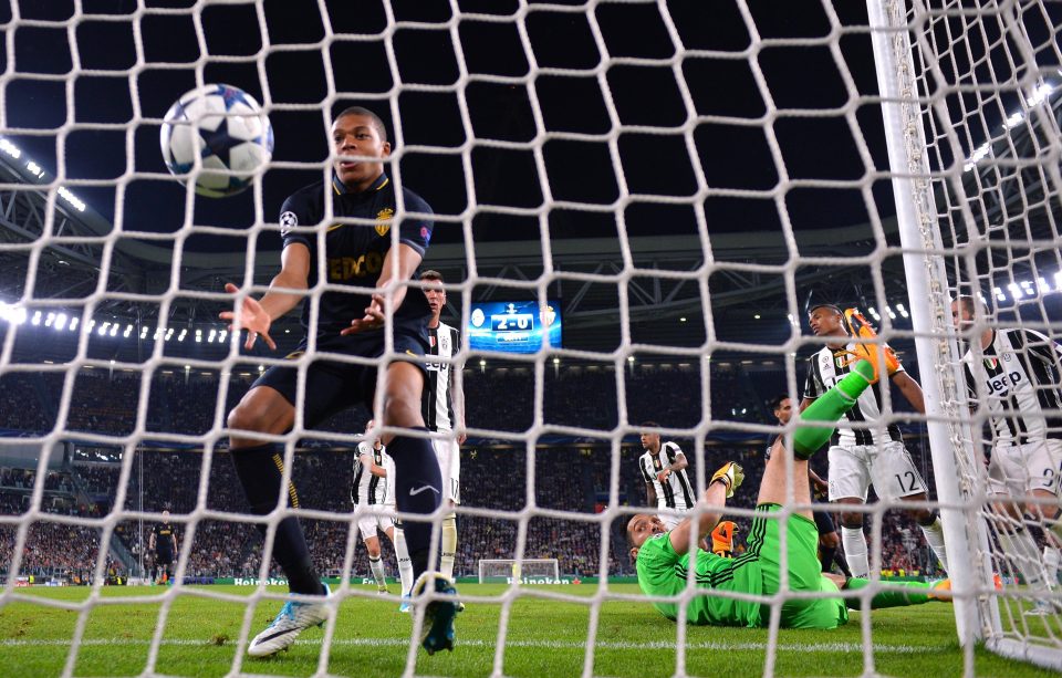 Kylian Mbappe chases the ball into the net after finding a way past Gianluigi Buffon