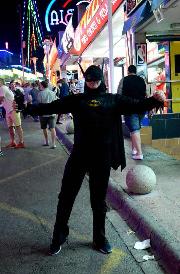  A man dressed as superhero Batman looks ready to take on all that Magaluf offers ahead of a boozy night out