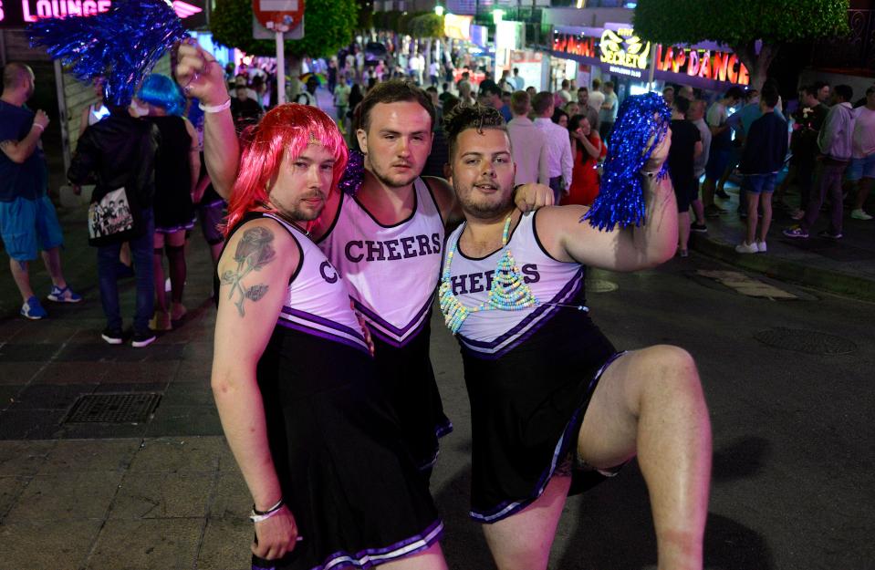  Three party-goers in cheerleading outfits pose for the camera as they party in the Spanish resort