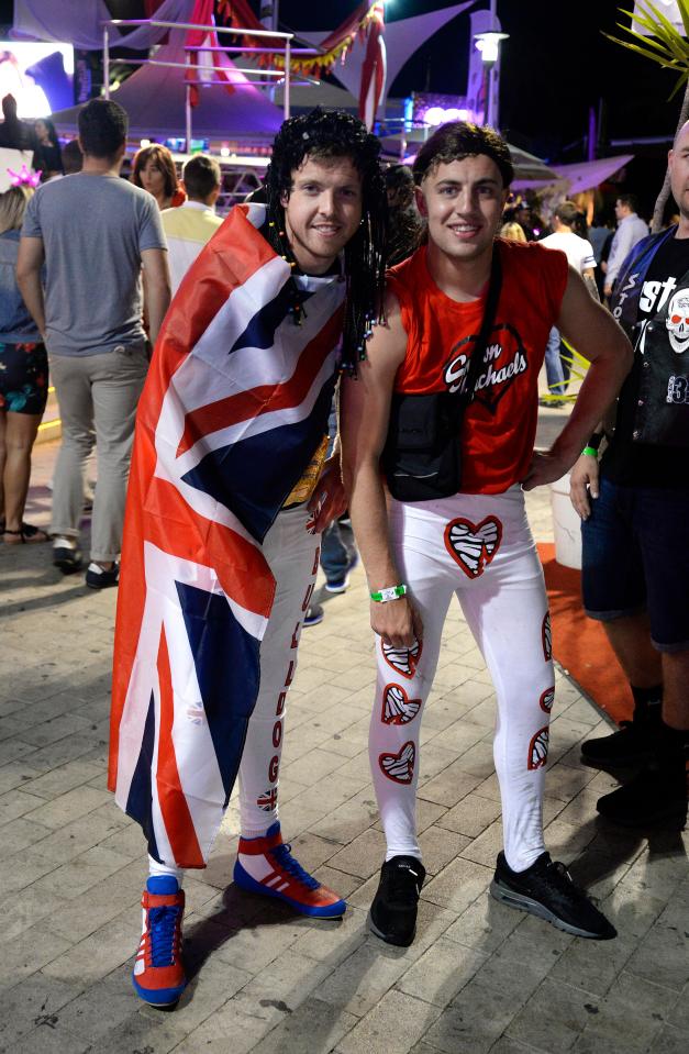  Two pals clad in a Union Jack and skin-tight leggings soak up the party atmosphere as they hit the town